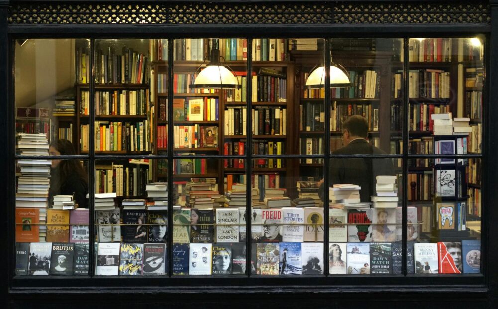 A cozy London bookstore showcasing various books through a classic window display.